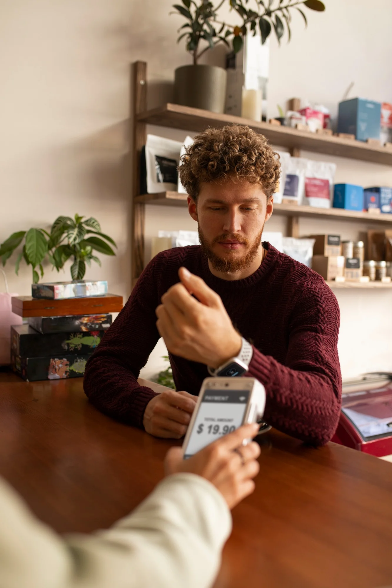 Small business owner testing a card reader, illustrating merchant activation and payment system configuration.